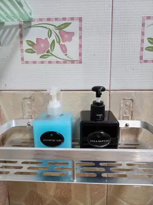 a sink with a bottle of soap and a soap dispenser at 211 Spacious studio with breezy fan full amenities with free Wi-Fi in Bangkok