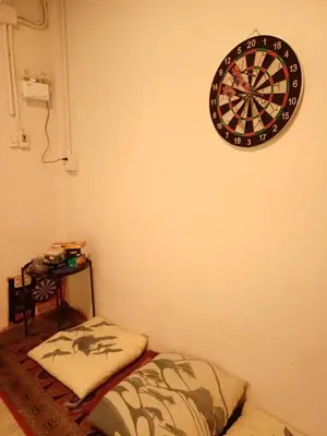 a dart board on the wall of a room at Amsterdamned (อัมสเตอร์ดัมด์) in Bangkok