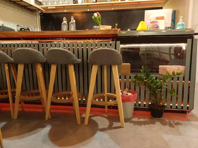 a group of stools in front of a bar at Amsterdamned (อัมสเตอร์ดัมด์) in Bangkok