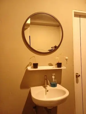 a bathroom with a sink and a mirror at Amsterdamned (อัมสเตอร์ดัมด์) in Bangkok