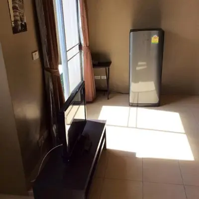 a room with a refrigerator in the corner of a room at The State Apartment in Bangkok