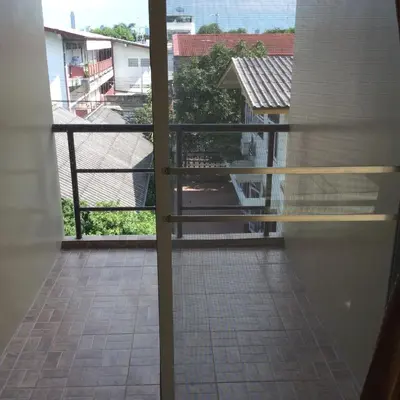 an open balcony with a view of a courtyard at The State Apartment in Bangkok