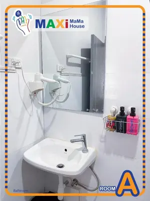 a bathroom with a sink and a mirror at MAXi MaMa House in Bangkok