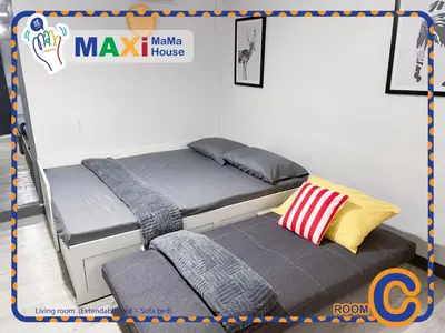two bunk beds in a room with avertisement for at MAXi MaMa House in Bangkok