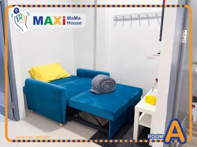 a room with a blue couch and a bed at MAXi MaMa House in Bangkok