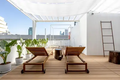 two chairs sitting on a balcony with plants at The Lair Bangkok - 3mins walk to ICON SIAM in Bangkok