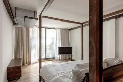 a bedroom with a bed and a flat screen tv at The Lair Bangkok - 3mins walk to ICON SIAM in Bangkok