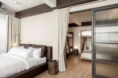 a bedroom with a large bed and a mirror at The Lair Bangkok - 3mins walk to ICON SIAM in Bangkok