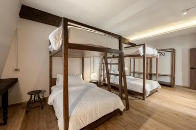 two bunk beds in a room with a piano at The Lair Bangkok - 3mins walk to ICON SIAM in Bangkok