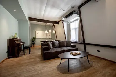 a living room with a couch and a table at The Lair Bangkok - 3mins walk to ICON SIAM in Bangkok