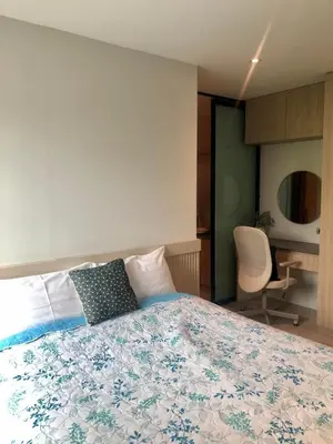 a bedroom with a bed and a desk and a chair at BaanTip​ HomStay in Bangkok
