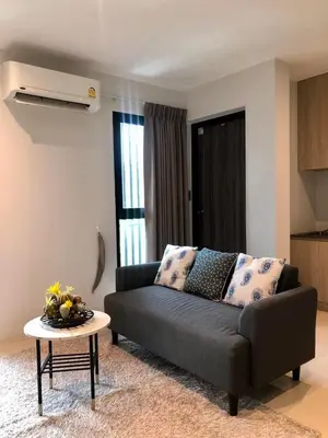 a living room with a couch and a table at BaanTip​ HomStay in Bangkok
