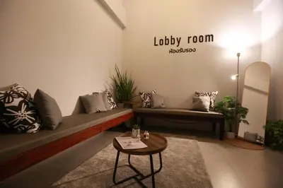 a living room with a couch and a table at BaanTip​ HomStay in Bangkok