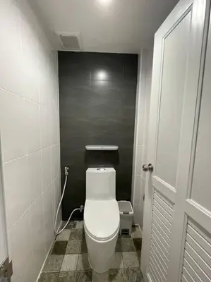 a small bathroom with a white toilet in a stall at Stay Tender in Bang Su