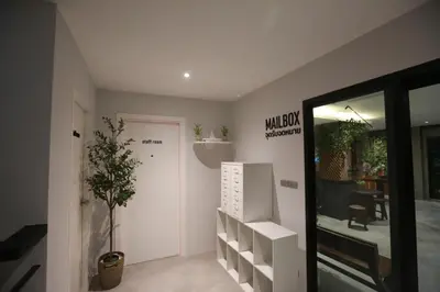 a room with a door and a plant in it at BaanTip​ HomeStay in Amphoe Phra Khanong