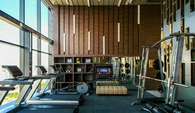 a gym with cardio equipment in a large room at Modern condo nr BTS ONNUT WIFI in Bangkok