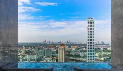 a view of a city from a building with a swimming pool at Modern condo nr BTS ONNUT WIFI in Bangkok