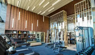 a gym with several treadmills and machines in a room at Modern condo nr BTS ONNUT WIFI in Bangkok
