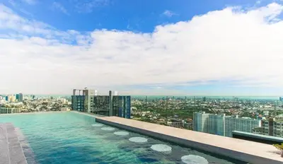 a swimming pool on the top of a building at Modern condo nr BTS ONNUT WIFI in Bangkok