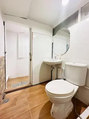 a bathroom with a white toilet and a sink at Chubby 5 Room 4 in Ban Bang Bamru