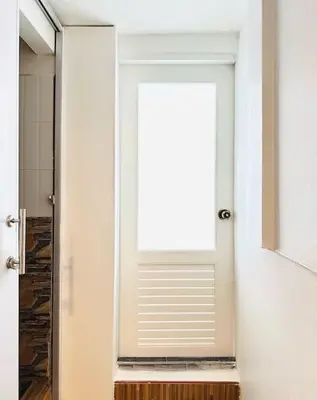 a white door with a window in a bathroom at Chubby 5 Room 4 in Ban Bang Bamru
