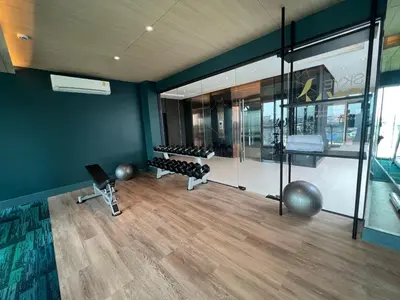 a room with a gym with exercise equipment in it at ARNI Skye Hotel in Bangkok