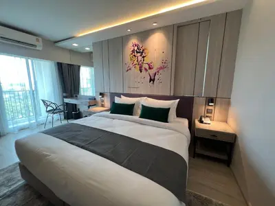 a bedroom with a large bed in a hotel room at ARNI Skye Hotel in Bangkok