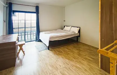 a small room with a bed and a window at Chubby 9 Standard room in Ban Bang Phlat