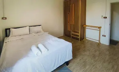 a bedroom with a bed with two pillows on it at Chubby 9 Standard room in Ban Bang Phlat