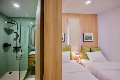 a bathroom with two beds and a shower at 3 Bed 3 Bath / Luxury / 1 min walk to BTS Asok in Bangkok