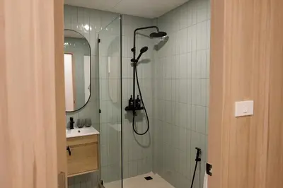 a bathroom with a shower and a sink at 3 Bed 3 Bath / Luxury / 1 min walk to BTS Asok in Bangkok