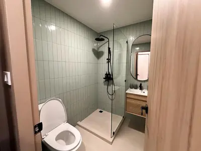 a bathroom with a toilet and a shower and a sink at 3 Bed 3 Bath / Luxury / 1 min walk to BTS Asok in Bangkok