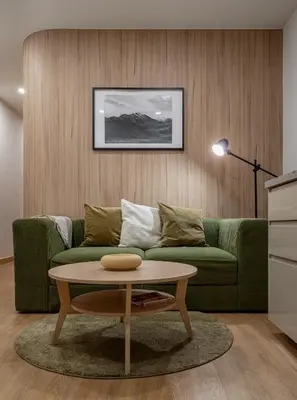 a living room with a green couch and a coffee table at 2 Bed 2 Bath / Luxury / 1 min walk to BTS Asok in Bangkok