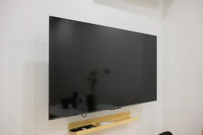 a large flat screen tv hanging on a wall at 2 Bed 2 Bath / Luxury / 1 min walk to BTS Asok in Bangkok