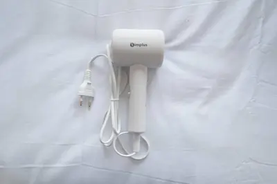 a white hair dryer hanging on a wall at MIQ Ekkamai3_Pool Villa_3BR house in Bangkok