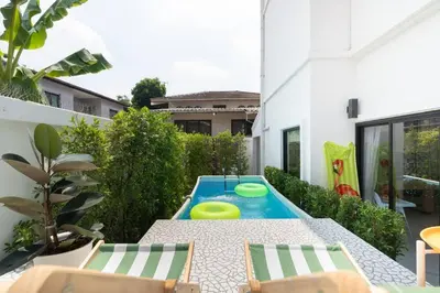 a backyard with a pool with two frisbees on it at MIQ Ekkamai3_Pool Villa_3BR house in Bangkok
