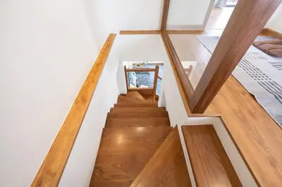 a staircase in a house with wooden floors at MIQ Ekkamai3_Pool Villa_3BR house in Bangkok