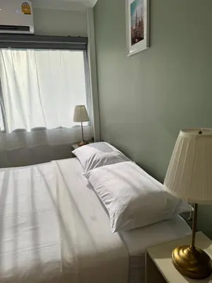 a bedroom with a white bed and a window at O'Shea's Sukhumvit Bangkok in Khlong Toei