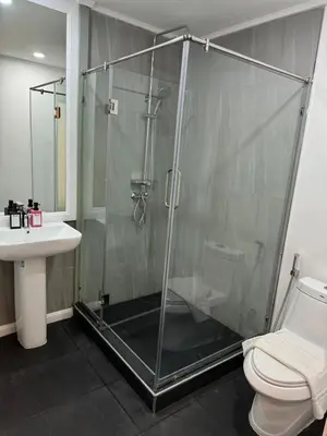 a bathroom with a shower and a toilet and a sink at O'Shea's Sukhumvit Bangkok in Khlong Toei