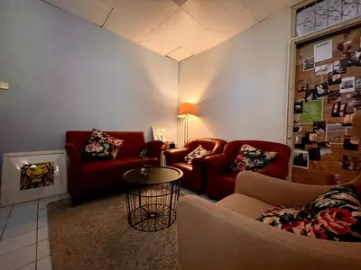 a living room with two couches and a table at MIDNIGHT CREPES Homecafe/Lifestyle Studio in Ban Bang Toei (1)