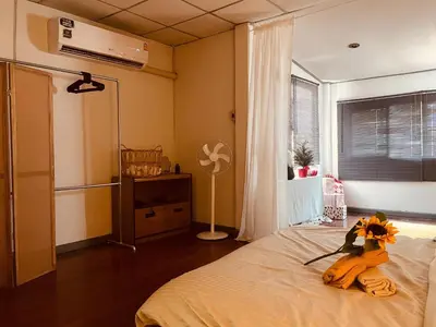 a bedroom with a bed with a stuffed animal on it at MIDNIGHT CREPES Homecafe/Lifestyle Studio in Ban Bang Toei (1)