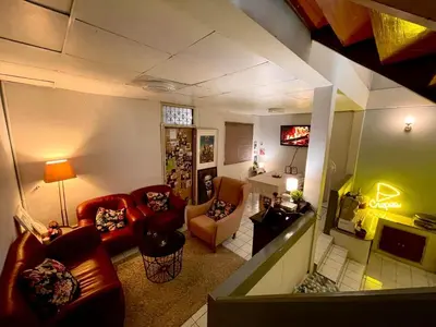 a living room with couches and chairs and a television at MIDNIGHT CREPES Homecafe/Lifestyle Studio in Ban Bang Toei (1)