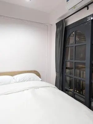 a bedroom with a white bed and a window at Cloud9 Hometel - Entire House 3BR 170m to BTS Private Quiet & Comfy in Bangkok