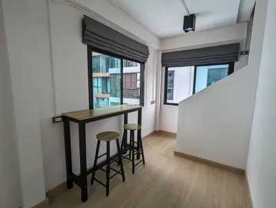 a small room with a table and two stools at Cloud9 Hometel - Entire House 3BR 170m to BTS Private Quiet & Comfy in Bangkok