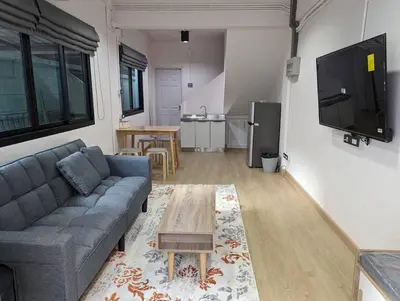 a living room with a couch and a table at Cloud9 Hometel - Entire House 3BR 170m to BTS Private Quiet & Comfy in Bangkok