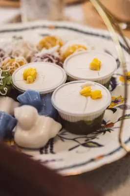 a plate with different types of food on it at Wallaya Heritage Stay in Bangkok