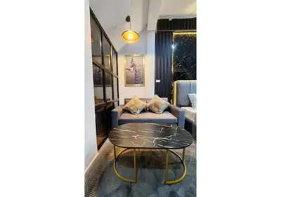 a living room with a table and a couch at Lasalle House - 4- storey entire house with rooftop 200 sqm Suvarnabhumi airport ,BTS in Bangkok
