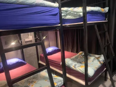 a group of bunk beds in a room at 24 hr Hostel in khaosan road in Bangkok