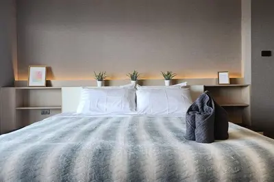 a bedroom with a large bed with white pillows at SelfCheckIn The State Tower RiverView 2Bedroom BTS ICONSIAM Silom Sathon in Bangkok