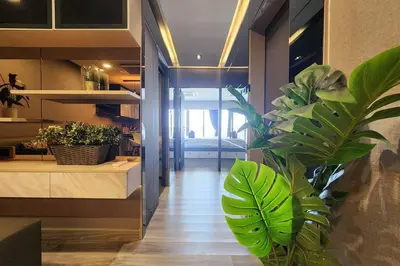 a hallway with a plant in the middle of a room at SelfCheckIn The State Tower RiverView 2Bedroom BTS ICONSIAM Silom Sathon in Bangkok